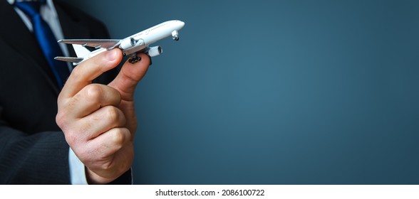 Businessman holding a airplane. Organization of flight traffic. Business and transport, air communication. Infrastructure for business development. Airline loyalty program. Tourism and travel.