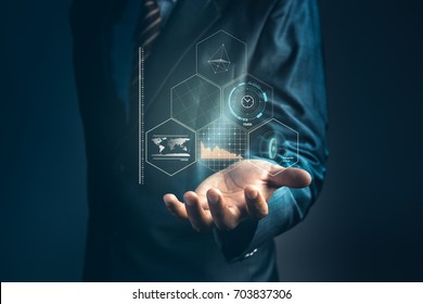 Businessman is holding to analyze marketing share information on hologram and connect to data with artificial intelligent system, Abstract of technology background and concept about internet of thing.