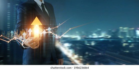 Businessman holding arrow up and analysis economic with graph of business growth, Business development to success and growth, finance and banking, marketing, strategy and planning to corporate. - Shutterstock ID 1986236864