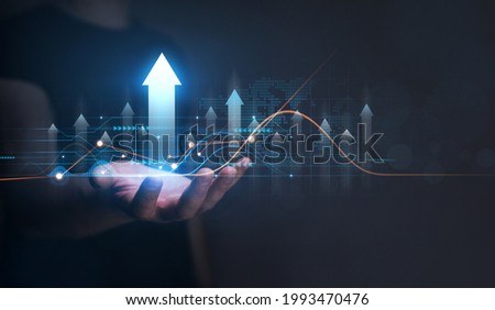 Businessman holding arrow up 
with graph of business analysis. Business development, financial plan and  strategy.