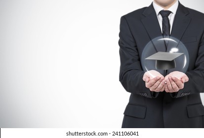 Businessman Holding Bachelor Of Science Hat