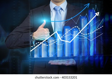 Businessman holding bar chart and graphs drawn on virtual screen, thumb raised up. Chest view. Concept of business analysis.