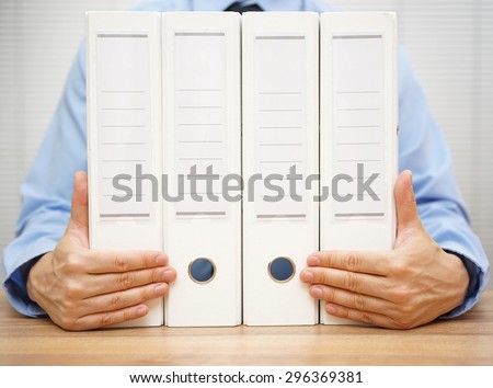 businessman holding binders.  accounting, finance or law concept