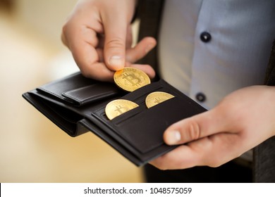 Businessman holding bitcoin.Golden bitcoin coins in man hands. Virtual currency. Crypto currency. New virtual money. Opened wallet.