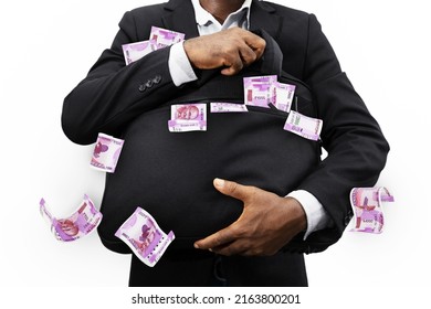 Businessman holding black bag full of Indian rupee notes isolated on white background, money falling from bag - Shutterstock ID 2163800201