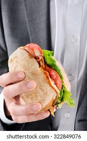 Businessman Holding To A BLT Sandwich, Busy Lunch On The Go, Hands Only 