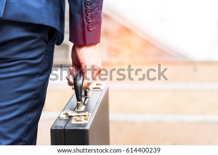 businessman holding briefcase and going to work time