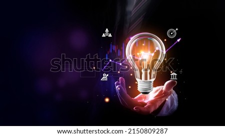 Businessman holding a bright light bulb. Concept of Ideas for presenting new ideas Great inspiration and innovation new beginning. Futuristic tone purple, neon color. Analyzing data