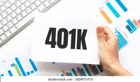 Businessman holding a card with text 401K. Keyboard, diagram and white background