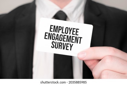 Businessman Holding A Card With Text Employee Engagement Survey