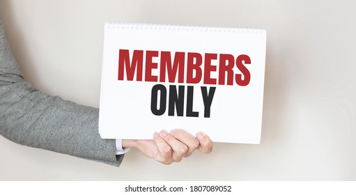 Businessman Holding A Card With Text MEMBERS ONLY