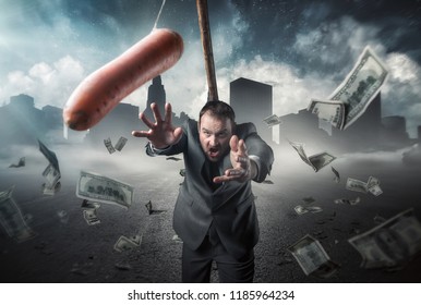 Businessman holding a carrot in a stick - Shutterstock ID 1185964234