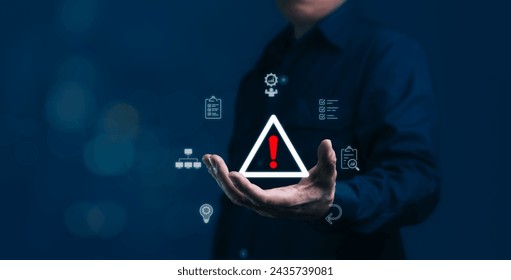 Businessman is holding caution symbol that is risk management, strategic control and assessment of risks, analysis aimed at achieving high performance and financial success - Powered by Shutterstock