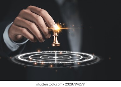 Businessman holding chess king with target, goal setting for success, leadership strategy or strategic planning and risk management. - Powered by Shutterstock