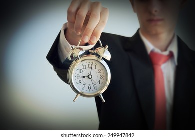 Businessman holding a clock - Shutterstock ID 249947842