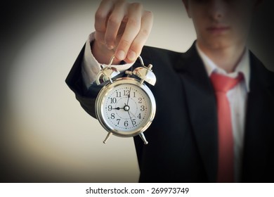 Businessman holding a clock - Shutterstock ID 269973749