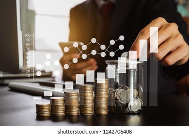 businessman holding coins putting in glass with using smartphone and calculator to calculate  concept saving money for finance accounting
 - Shutterstock ID 1242706408