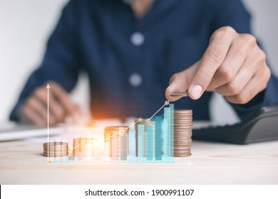 businessman holding coins putting in glass. concept saving money for finance accounting to arrange coins into growing graphs concept.