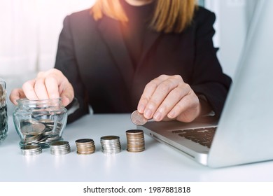 businessman holding coins putting in glass and using calculator. concept saving money and finance accounting. - Shutterstock ID 1987881818