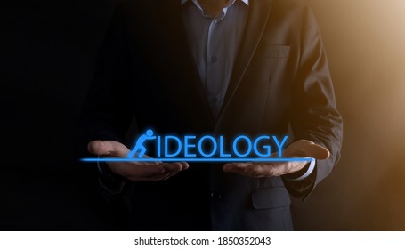 Businessman holding a concept in his hands.The silhouette of man pushes the word IDEOLOGY.business economy concept. - Shutterstock ID 1850352043