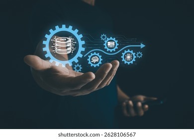 Businessman holding a digital gear icon symbolizing the ETL process in cloud data management, surrounded by related technology icons. AI industrial and smart business and automation solution.