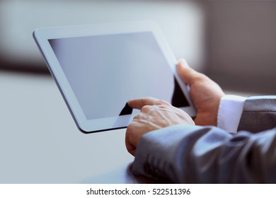 Businessman holding digital tablet in office