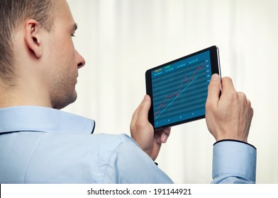 Businessman Holding Digital Tablet with stock market diagram