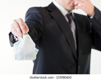 Businessman Holding A Dirty Diaper