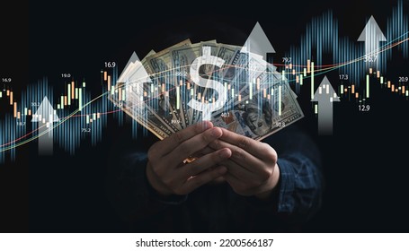 Businessman Holding Dollar Banknote With Stock Market Graph And Up Arrow For Inflation And Interest Rating Increasing Concept.