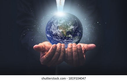Businessman holding the earth with global connection concept. Energy saving concept, Elements of this image furnished by NASA