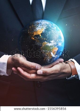 Businessman Holding Earth. Save Earth Concept. Elements of this image furnished by NASA