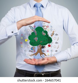 businessman holding education tree on gray background - Powered by Shutterstock