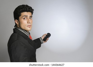 Businessman Holding A Flashlight