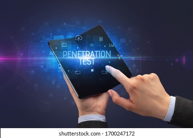 Businessman holding a foldable smartphone with PENETRATION TEST inscription, cyber security concept