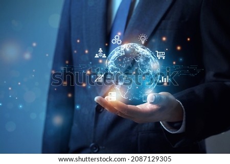   Businessman holding the future world of the metaverse, internet technology, networking applications around the world. create a virtual image of Global Internet connection application technology.