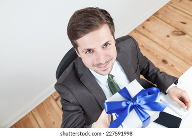 businessman holding a gitft box