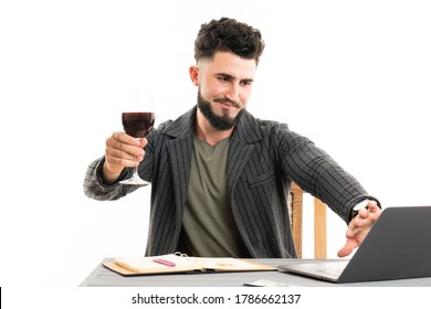 Businessman Holding The Glass Of Red Wine And Gesturing Stop Sign By His Palm To The Web Cam On His Laptop. Represents Outcry Alcoholic Dependency