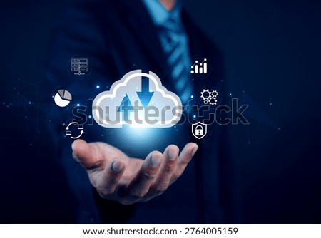 Businessman holding glowing cloud computing icon with data transfer arrows, representing digital transformation, cloud storage, cybersecurity, analytics, and network technology