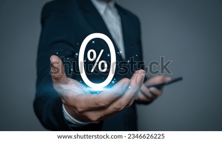 Businessman holding glowing zero percent or 0 percent for discounts Interest rates, installments, promotions, marketing, tax payment.