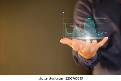 Businessman Holding Graph With Analyze Sales Data And An Economic Graph Chart In Order To Restart Business Growth.