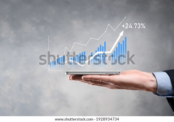 Businessman holding graph growth and increase of\
chart positive indicators in his business.Investment up\
concept.analyzing sales data and economic,strategy and planning,\
Digital marketing and\
stock
