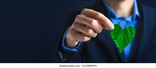 Businessman Holding A Green Heart Leaf  Business With Corporate Social Responsibility And Environmental Concern. Environmental And Ecology Care Concept.. ESG Concept. Nature 