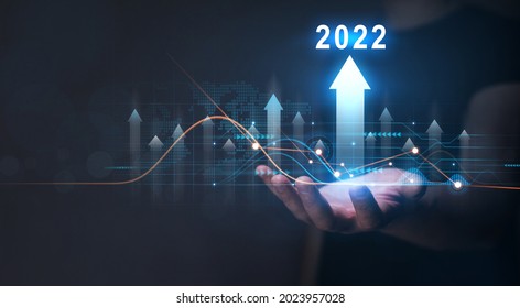 Businessman Holding Growth Graph With Year 2022. 
Corporate Future Growth Plan In New Year 2022.Development To Success And Growth Business Concept. 