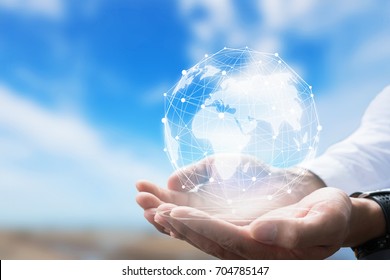 Businessman holding in hand with global connection concept.