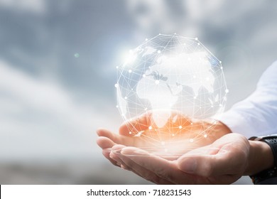 Businessman holding in hand with global connection concept. - Shutterstock ID 718231543