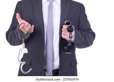 Businessman Holding Handcuffs And Ball Gag.