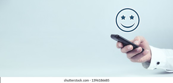 Businessman holding happy icon. Customer experience concept - Shutterstock ID 1396186685