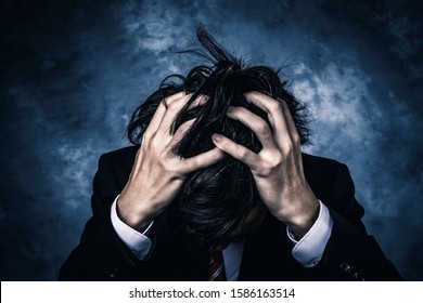 Businessman holding his head in despair