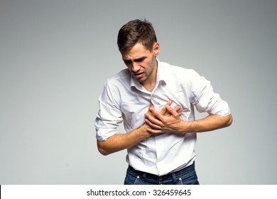 Businessman Holding His Heart In Pain