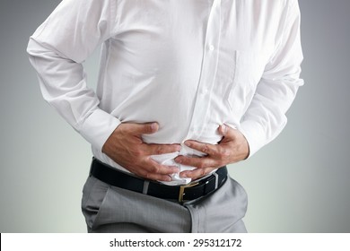 Businessman Holding His Stomach In Pain With  Stomachache Or Indigestion